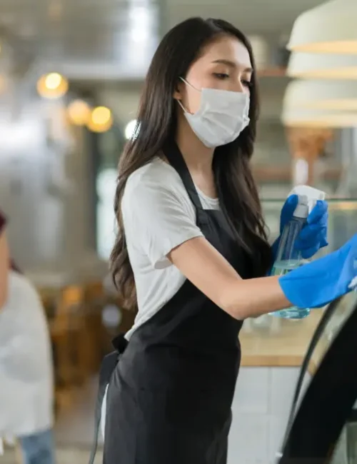attractive-positive-young-asian-woman-staff-uniform-apron-spraying-detergent-alcohol-counter-product-cabinet-wiping-it-with-soft-cloth-when-disinfecting-cafe-ther-morning-safe-clean