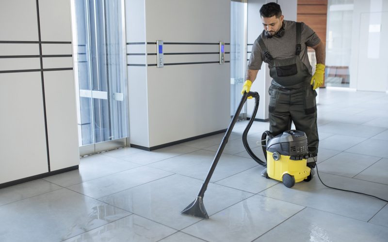 full-shot-man-vacuuming-office-floor